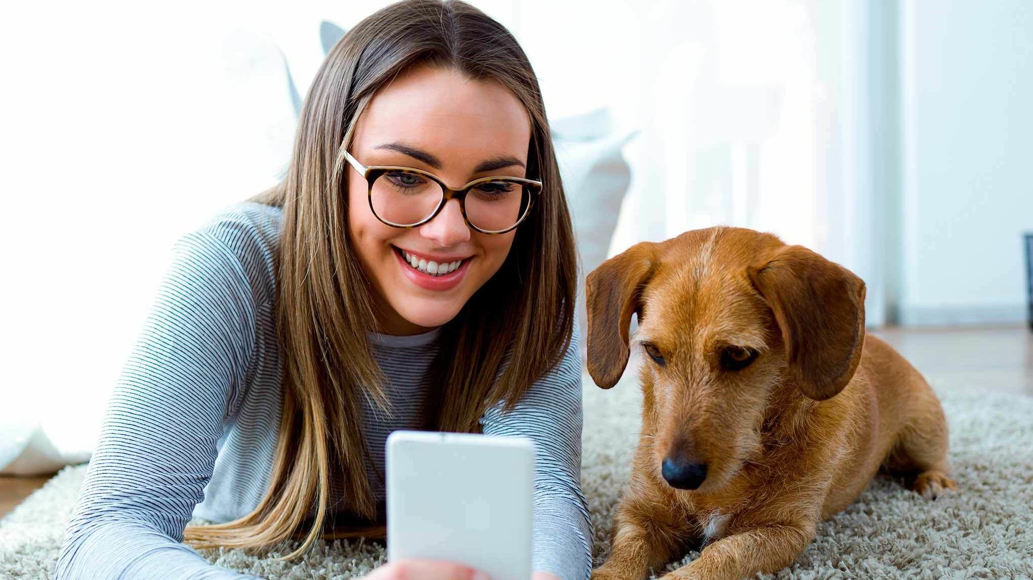 Girl with brown dog and phone